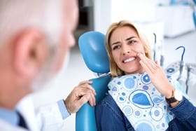 Woman with toothache at dentist’s