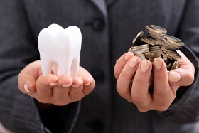 Tooth and money in each hand