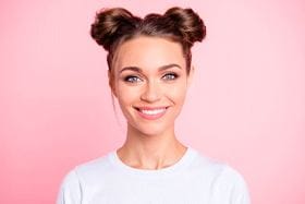 woman smiling with pink background 