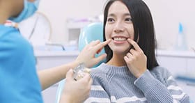 Woman discussing teeth at dentist office