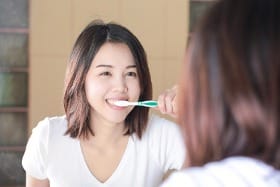 Woman brushing teeth