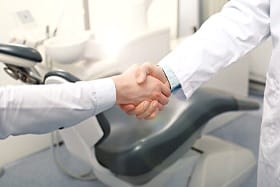 Patient and dentist shaking hands
