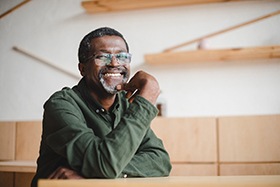 An older gentleman with glasses is happy because of the renewed confidence in his smile