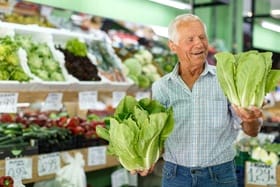 person shopping for produce in a grocery store