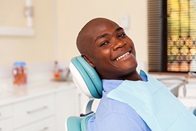 man smiling after getting dental implants in Dallas
