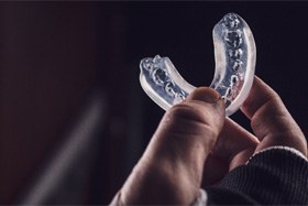 Hand holding a mouthguard used for sports 