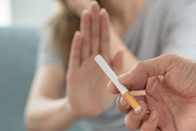 Woman declining the offer of a cigarette