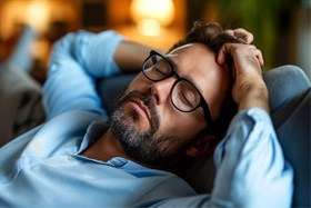 Man resting peacefully on sofa at home