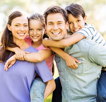 family of four smiling