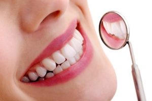 Healthy teeth in dental mirror