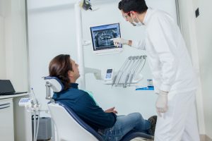 dentist showing patient dental x-rays