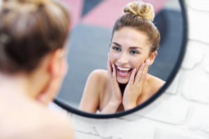 Young woman smiling in the mirror