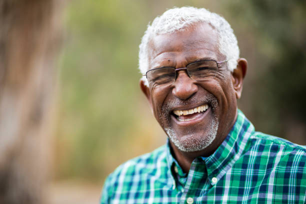 older person who got dental implants after menopause smiling 